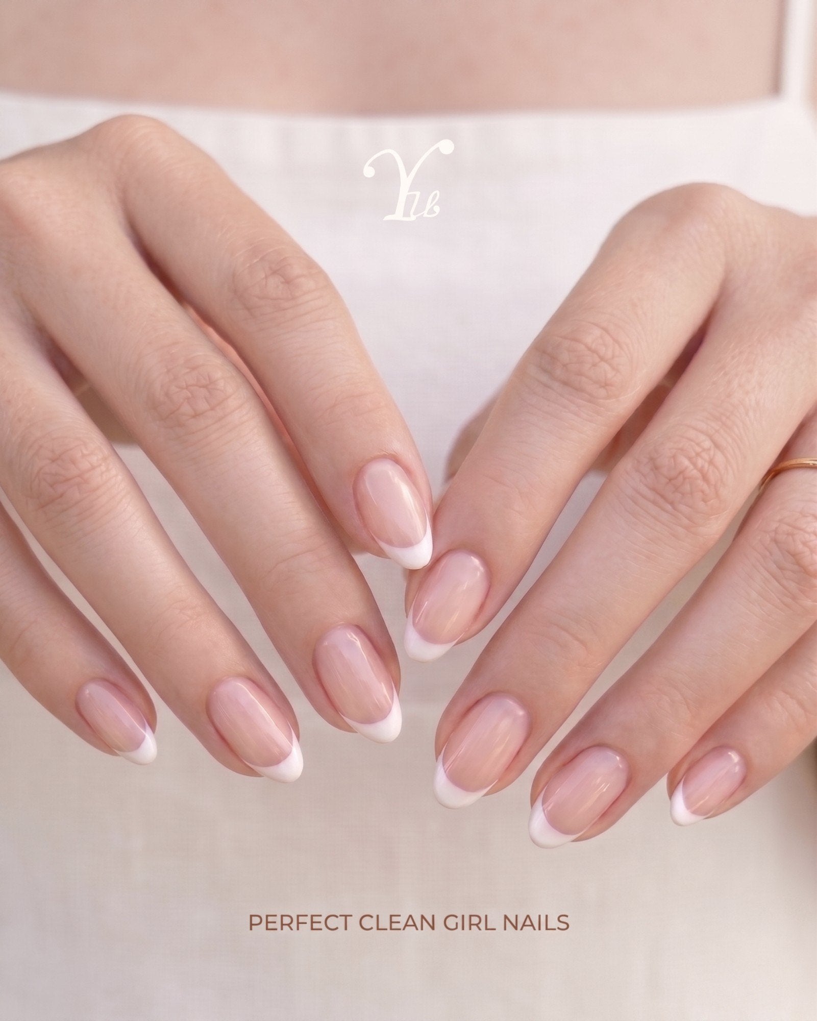 Almond nails with a white French tip, hands held together